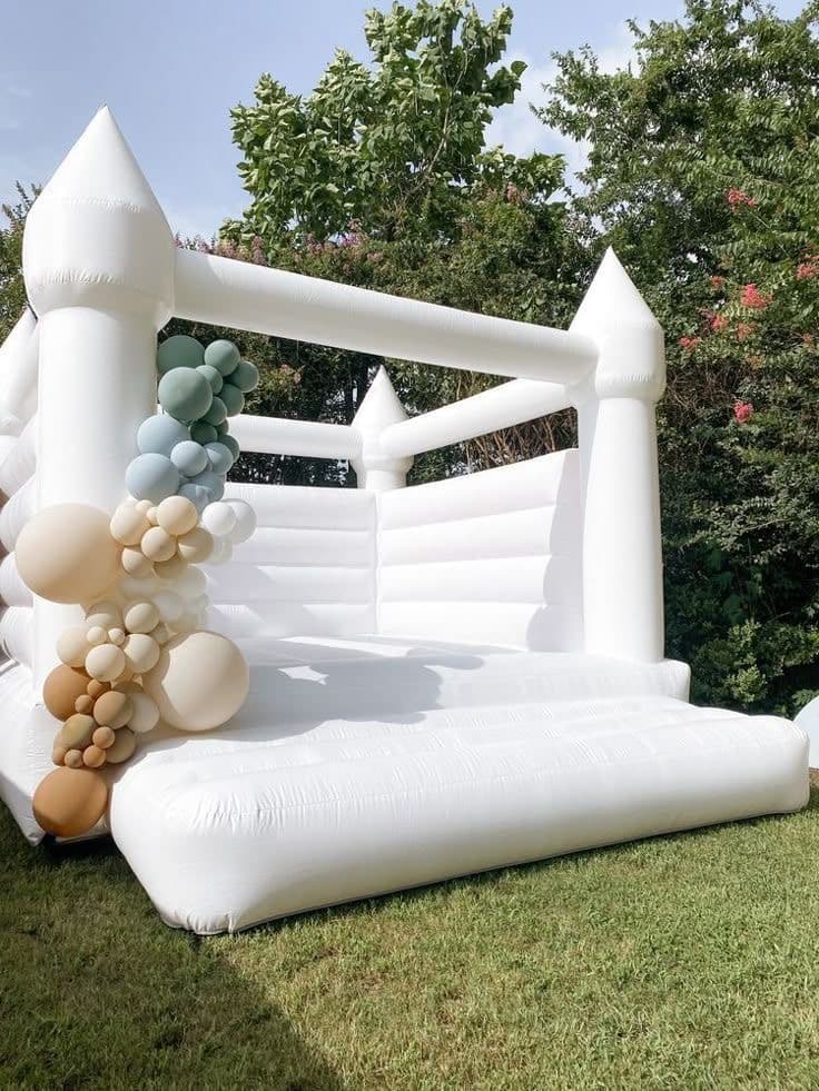 White Bounce House Half Arch White bounce house with neutral balloon garland in Miami