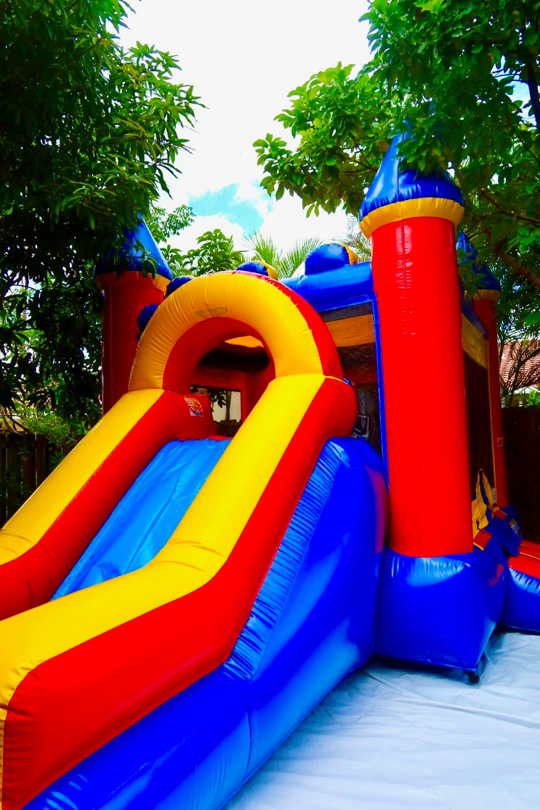 Combo Slide Bounce House Bright red yellow and blue slide bounce house rental in Miami